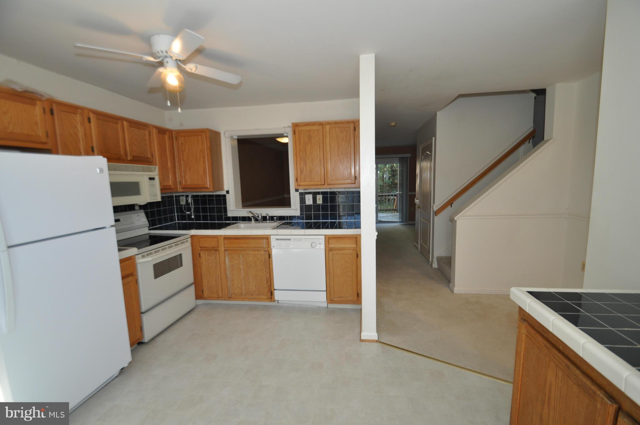 1109 Oak View Drive Mount Airy, MD 21771 - Photo 2 of 18 a kitchen with granite countertop a stove a sink and a refrigerator