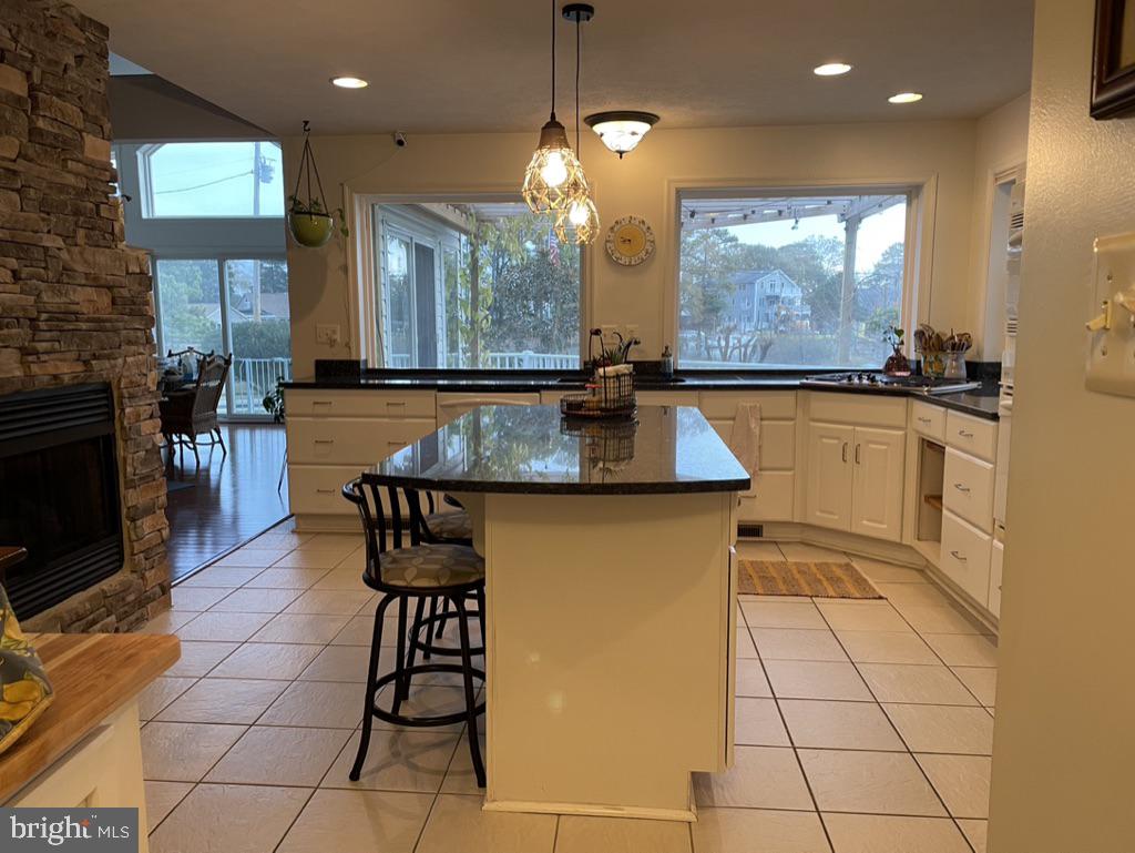 17451 Poplar Street Piney Point, MD 20674 - Photo 12 of 27 a kitchen with stainless steel appliances granite countertop a stove a sink and a microwave