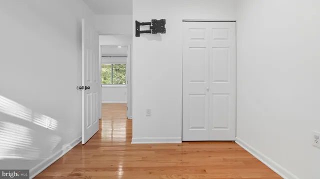 a view of staircase with railing and white walls