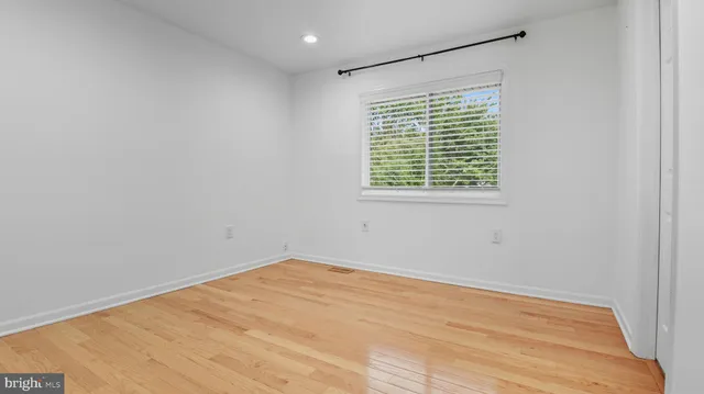 a view of staircase with lots of frames on wall and a window