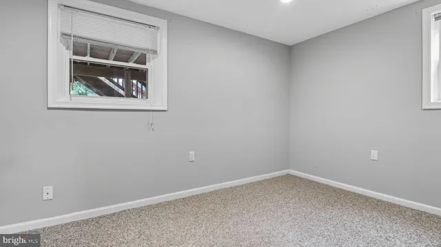 a front view of house with a garden and trees