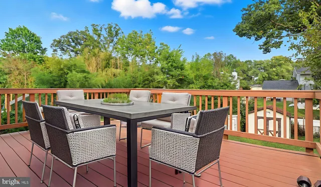 a living room with furniture kitchen and a large window