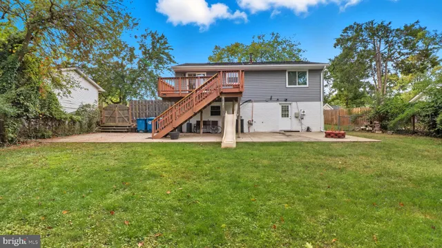 a kitchen with stainless steel appliances granite countertop a table chairs and a refrigerator