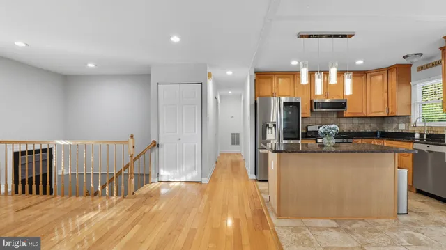a bathroom with a double vanity sink mirror and toilet