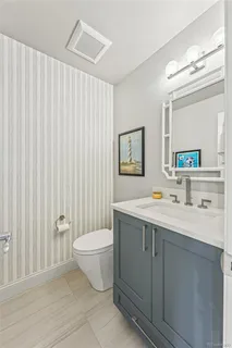 a view of bathroom with a toilet sink and mirror
