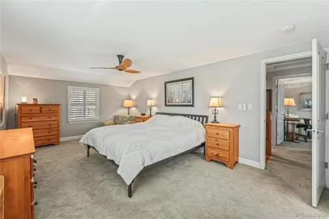 a spacious bedroom with a bed and dresser