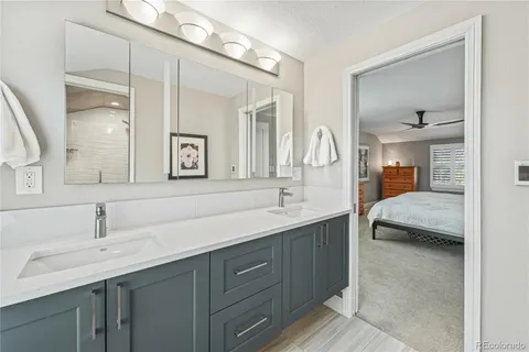 a en suite bathroom with a double vanity sink and a mirror