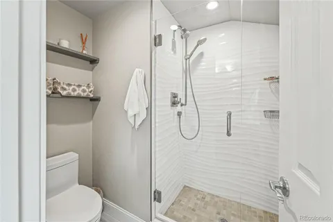 a bathroom with a shower and toilet