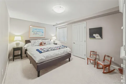 a bedroom with a bed and a lamp