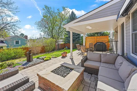 a view of a patio with couches and a table and chairs with garden view