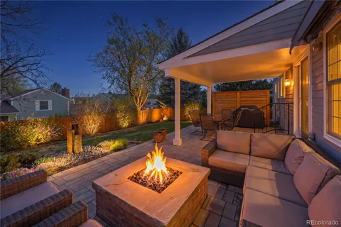 a outdoor living space with furniture and a fireplace