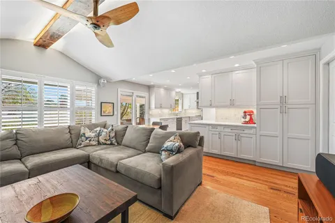 a living room with furniture and kitchen view