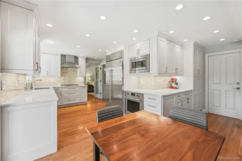 a large kitchen with kitchen island a sink stainless steel appliances and cabinets
