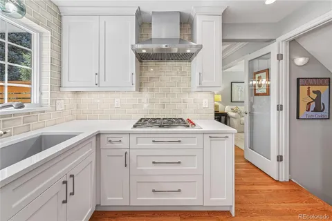 a kitchen with stainless steel appliances white cabinets and a sink