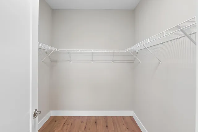 a view of a room with wooden floor