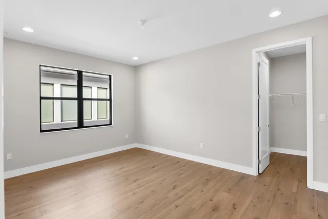 wooden floor in an empty room with a window
