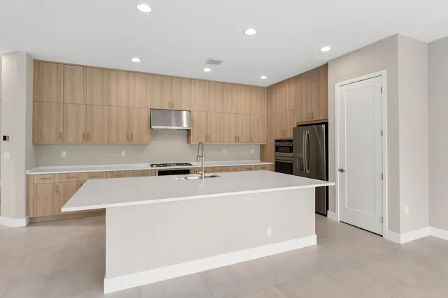 a refrigerator freezer sitting inside of a kitchen