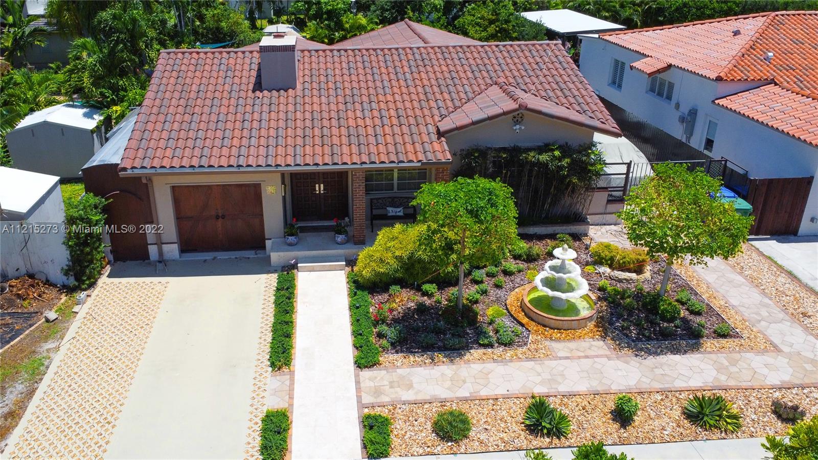 619 Southwest 20th Road Miami, FL 33129 - Photo 1 of 25 a front view of a house with a yard and potted plants