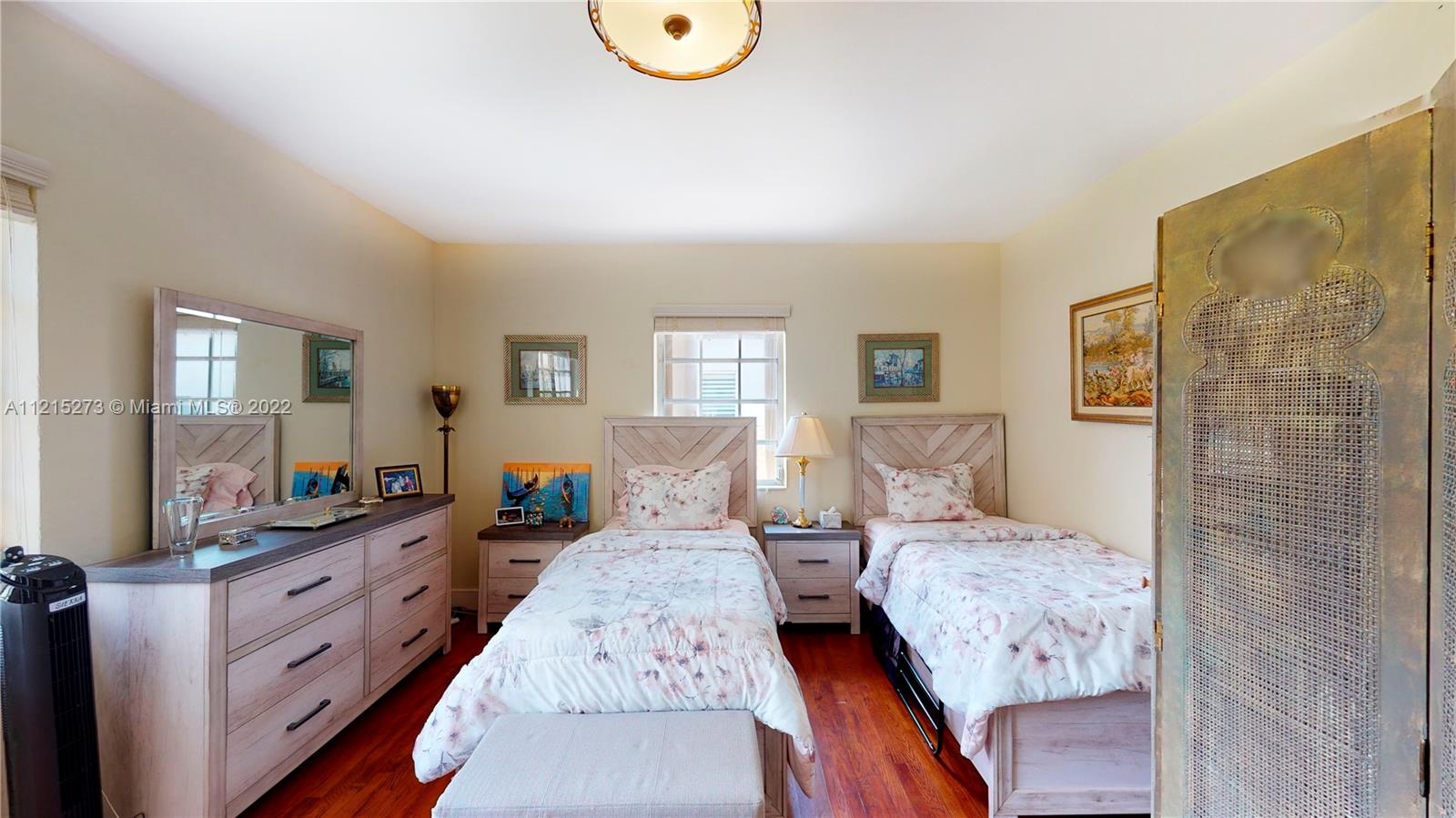 619 Southwest 20th Road Miami, FL 33129 - Photo 14 of 25 a large bedroom with a large bed and wooden floor