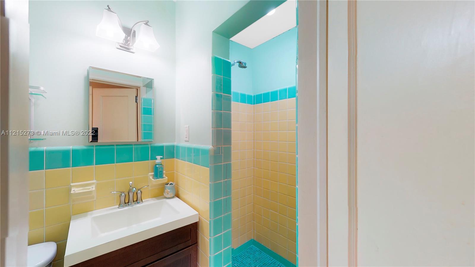 619 Southwest 20th Road Miami, FL 33129 - Photo 15 of 25 a bathroom with a sink and a mirror