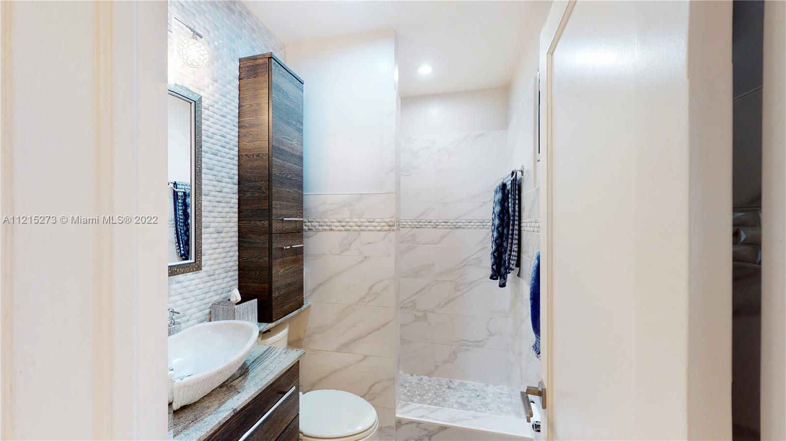 619 Southwest 20th Road Miami, FL 33129 - Photo 16 of 25 a bathroom with a sink toilet and shower