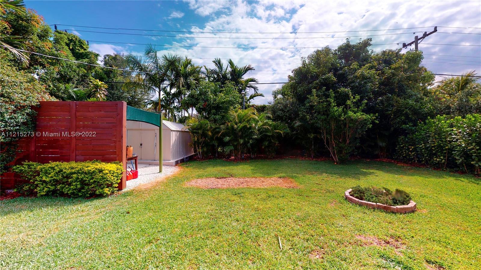 619 Southwest 20th Road Miami, FL 33129 - Photo 19 of 25 a view of a backyard with plants and a bench