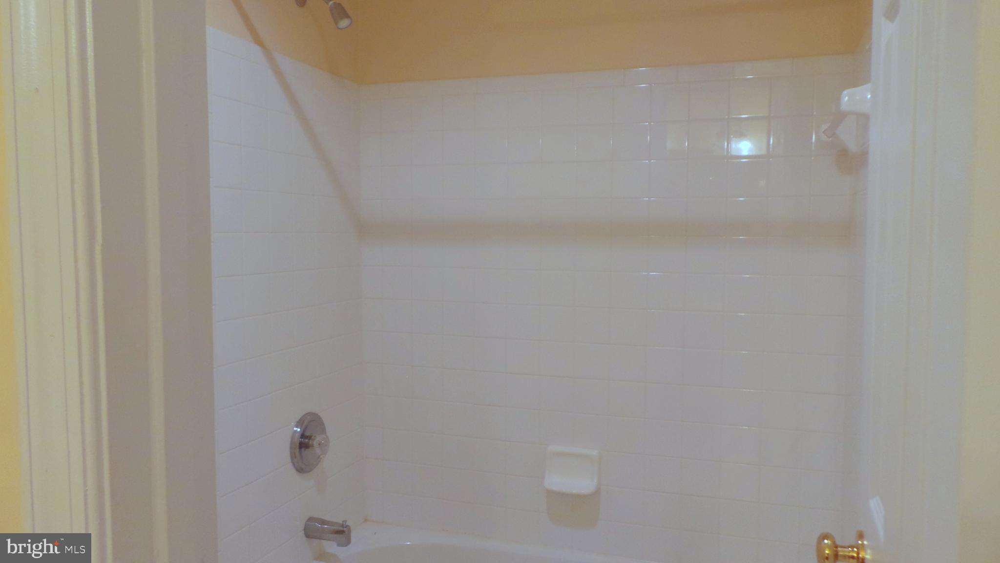 625 Ruxton Road, Unit 73 Solomons, MD 20629 - Photo 24 of 50 Tiled Tub/Shower in Jack & Jill Bathroom