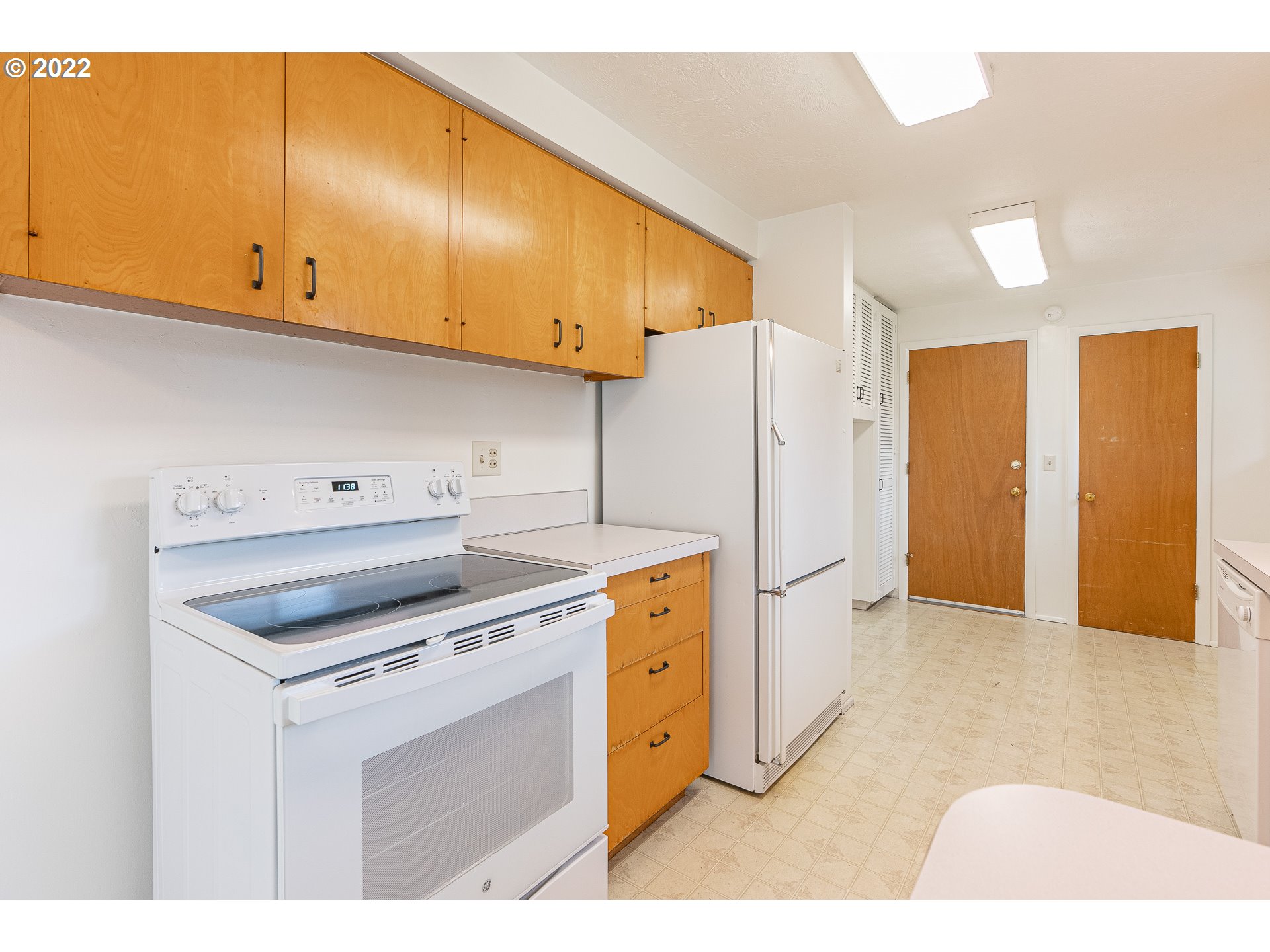 2900 Manor Drive Springfield, OR 97477 - Photo 12 of 32 a kitchen with a stove a refrigerator and cabinets
