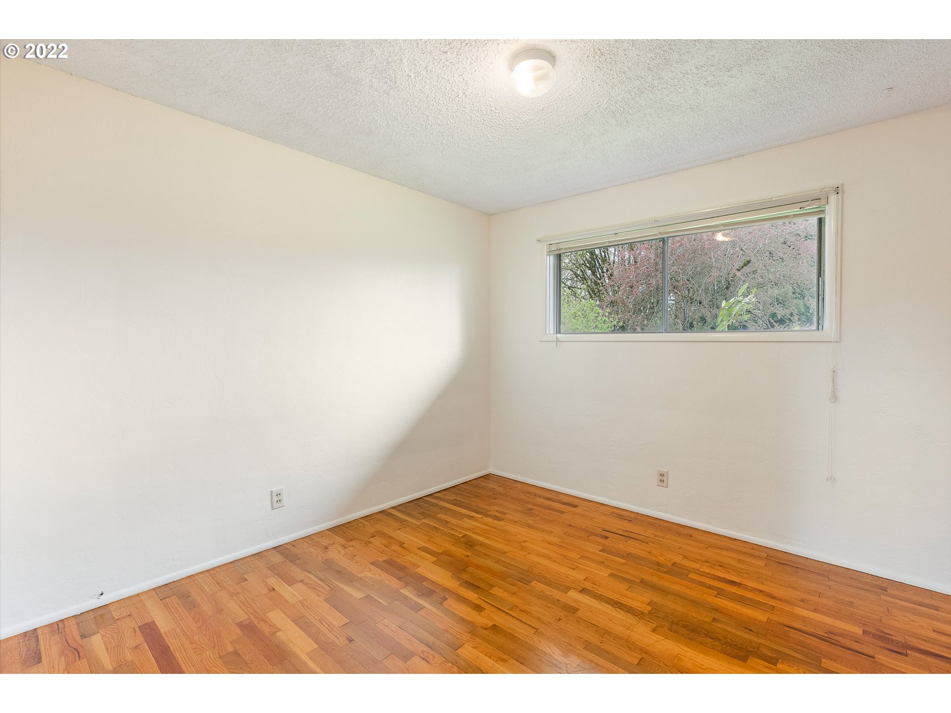 2900 Manor Drive Springfield, OR 97477 - Photo 21 of 32 an empty room with wooden floor and windows