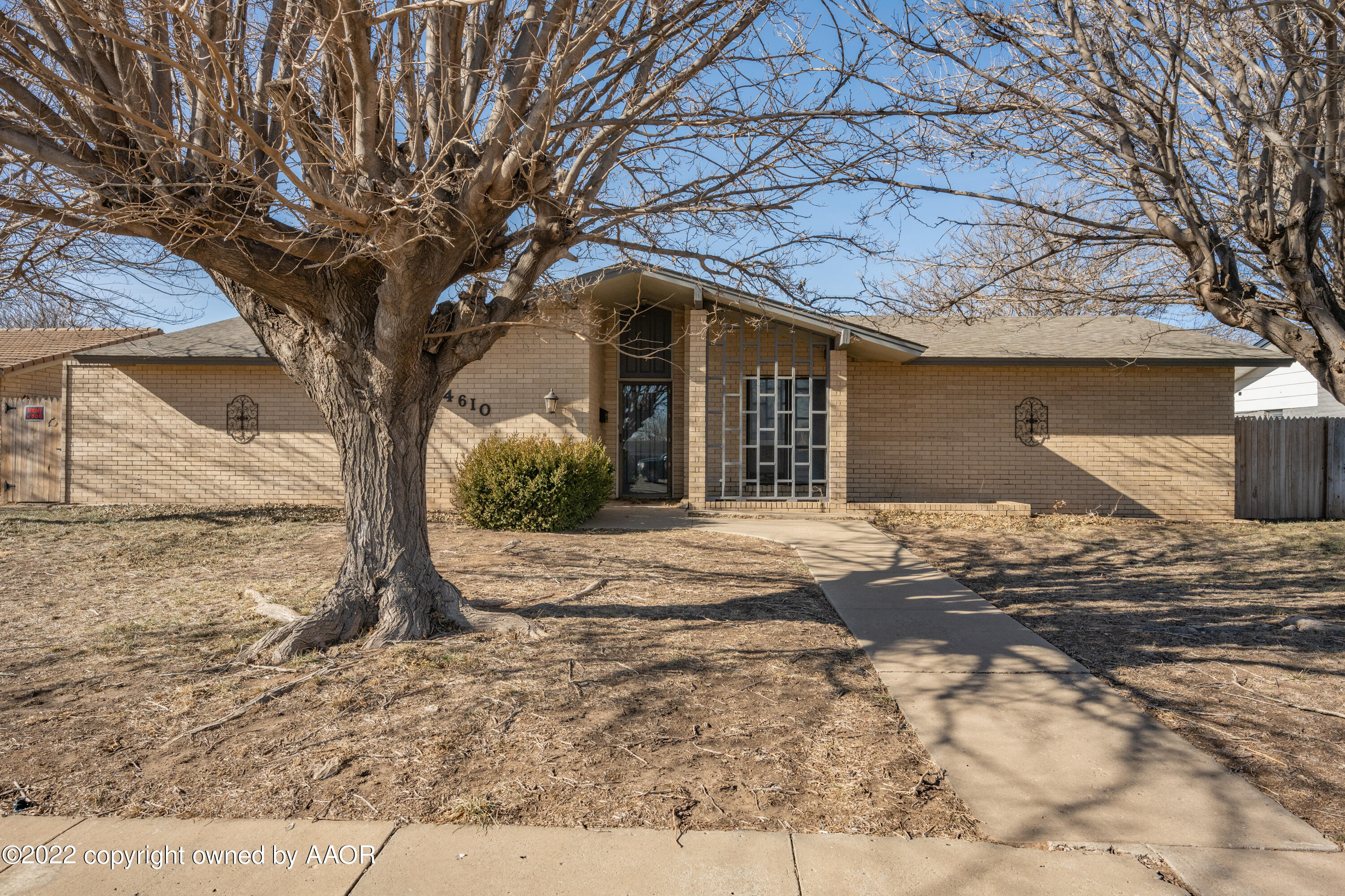 4610 South Georgia Street Amarillo, TX 79110 - Photo 1 of 25 a front view of a house with a yard and garage