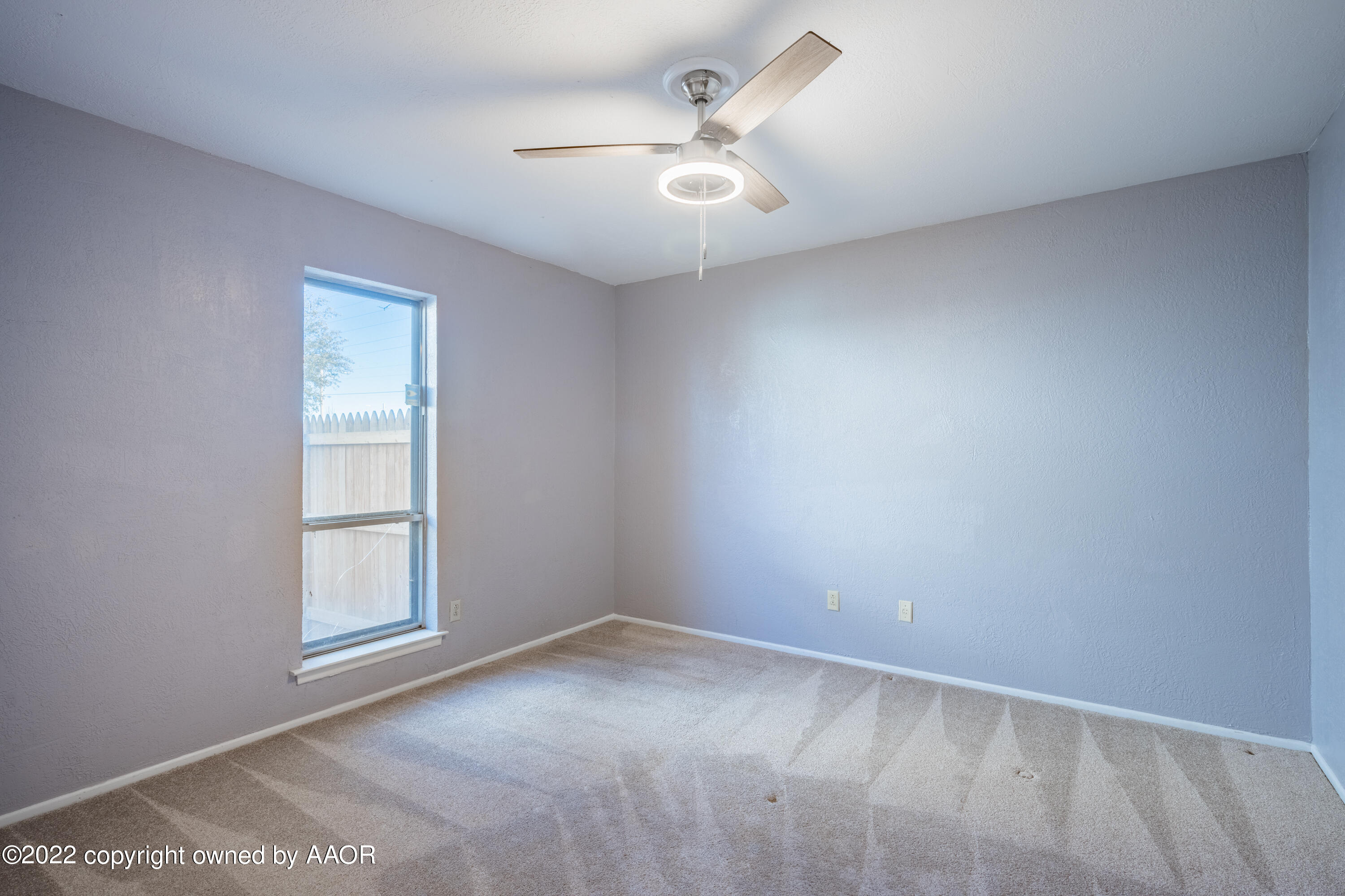 4610 South Georgia Street Amarillo, TX 79110 - Photo 13 of 25 an empty room with windows and ceiling fan