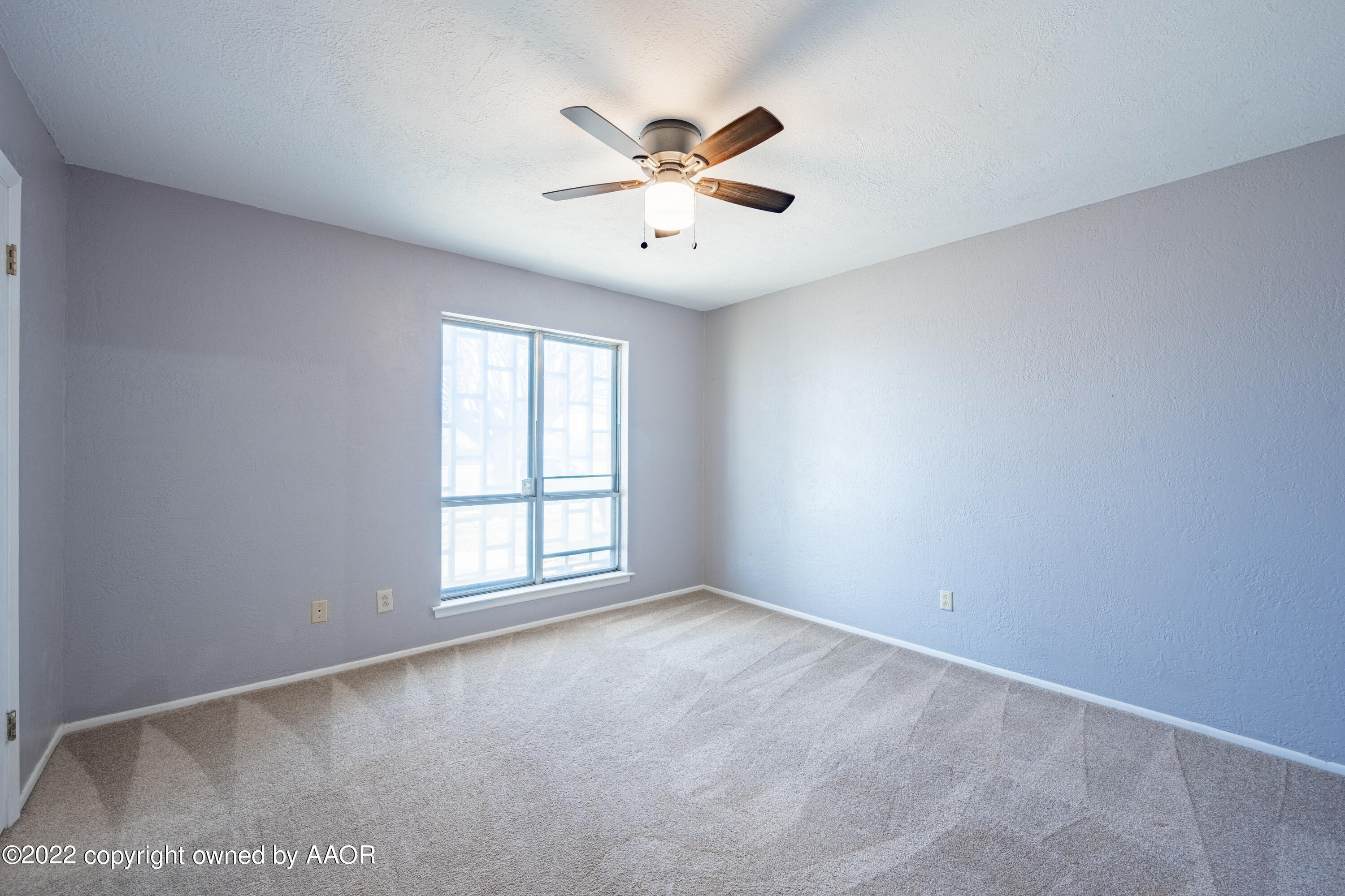 4610 South Georgia Street Amarillo, TX 79110 - Photo 14 of 25 an empty room with windows and ceiling fan