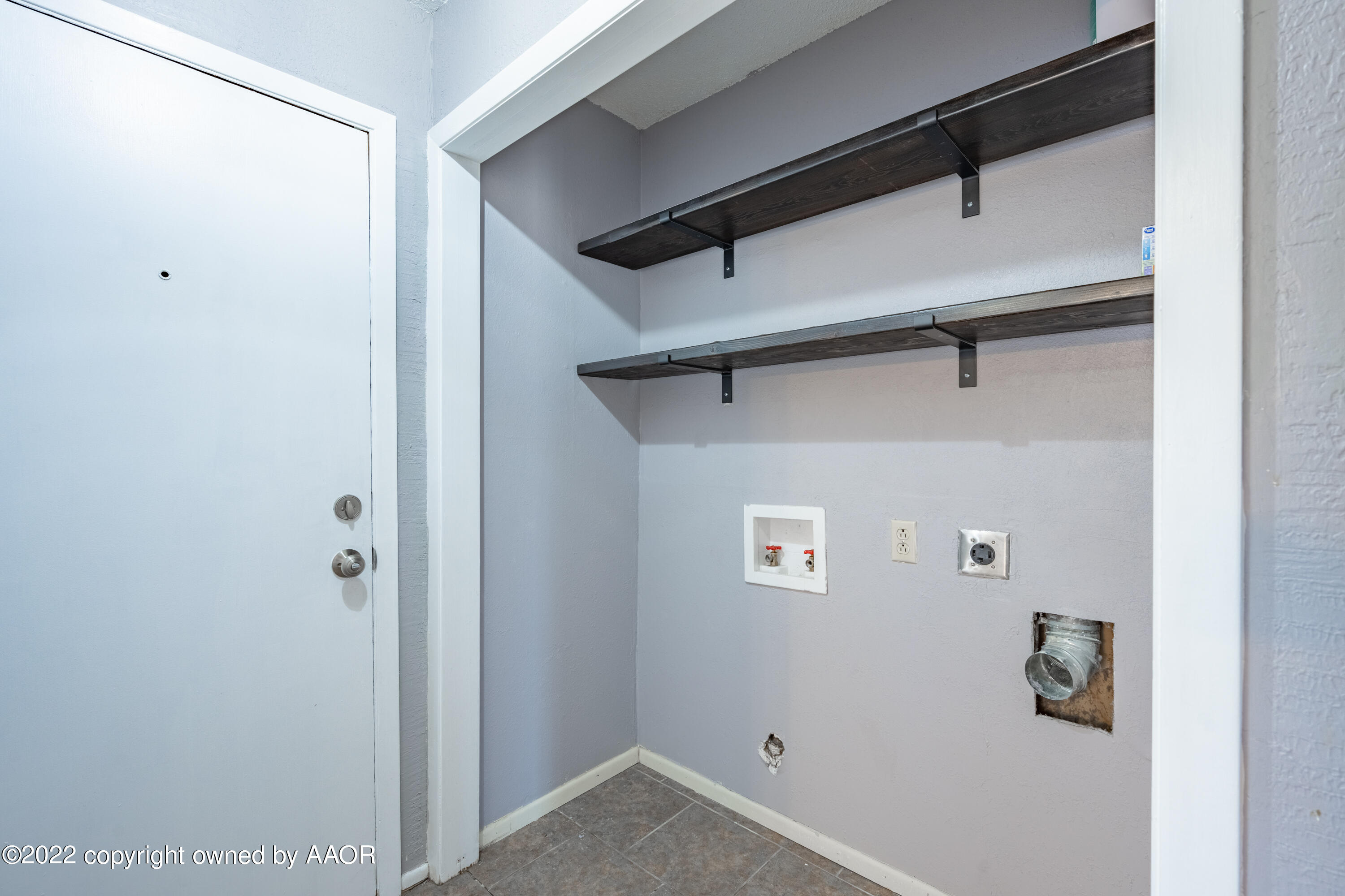 4610 South Georgia Street Amarillo, TX 79110 - Photo 17 of 25 a view of storage and utility room with racks on the wall