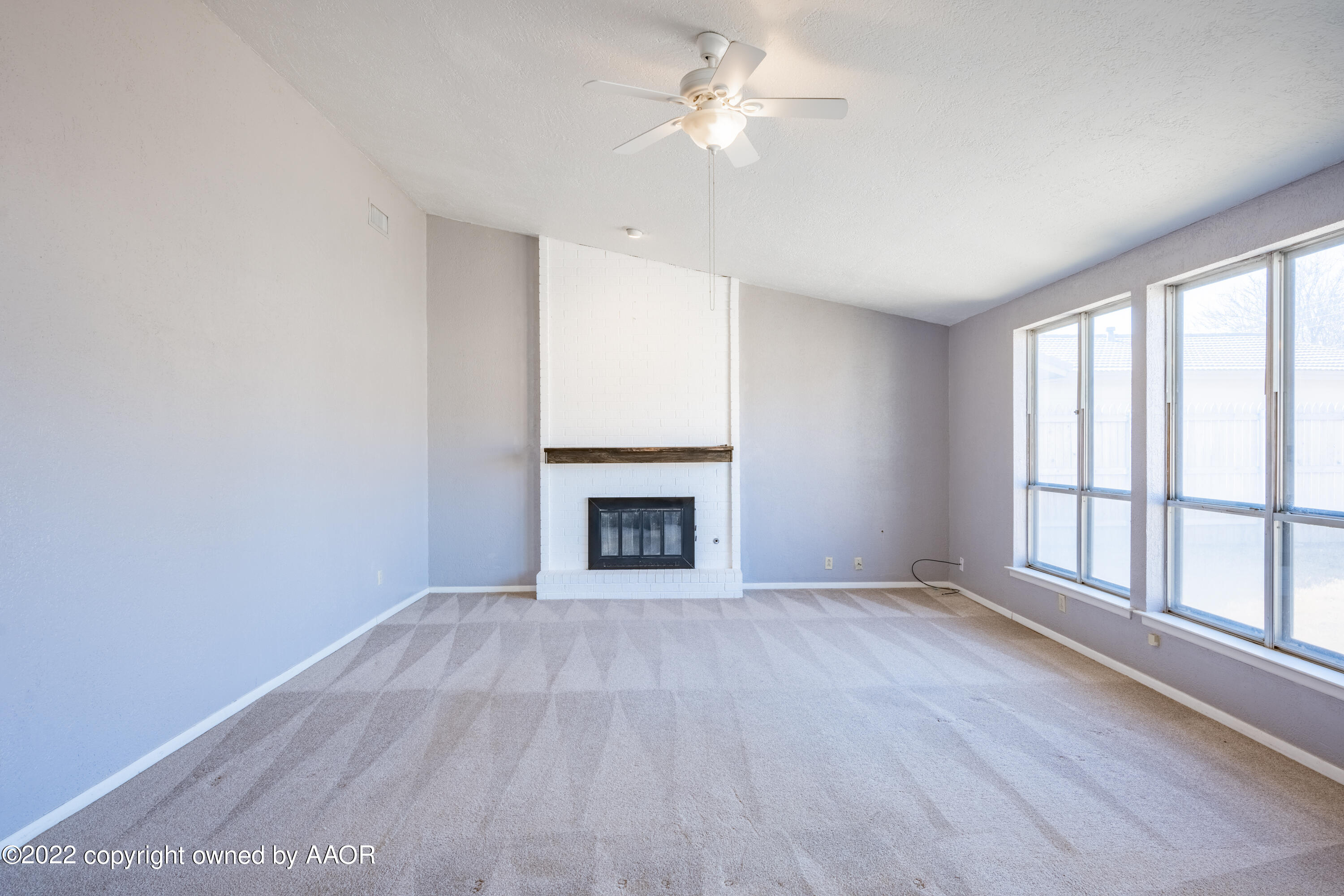 4610 South Georgia Street Amarillo, TX 79110 - Photo 3 of 25 a view of an empty room with a window and fireplace