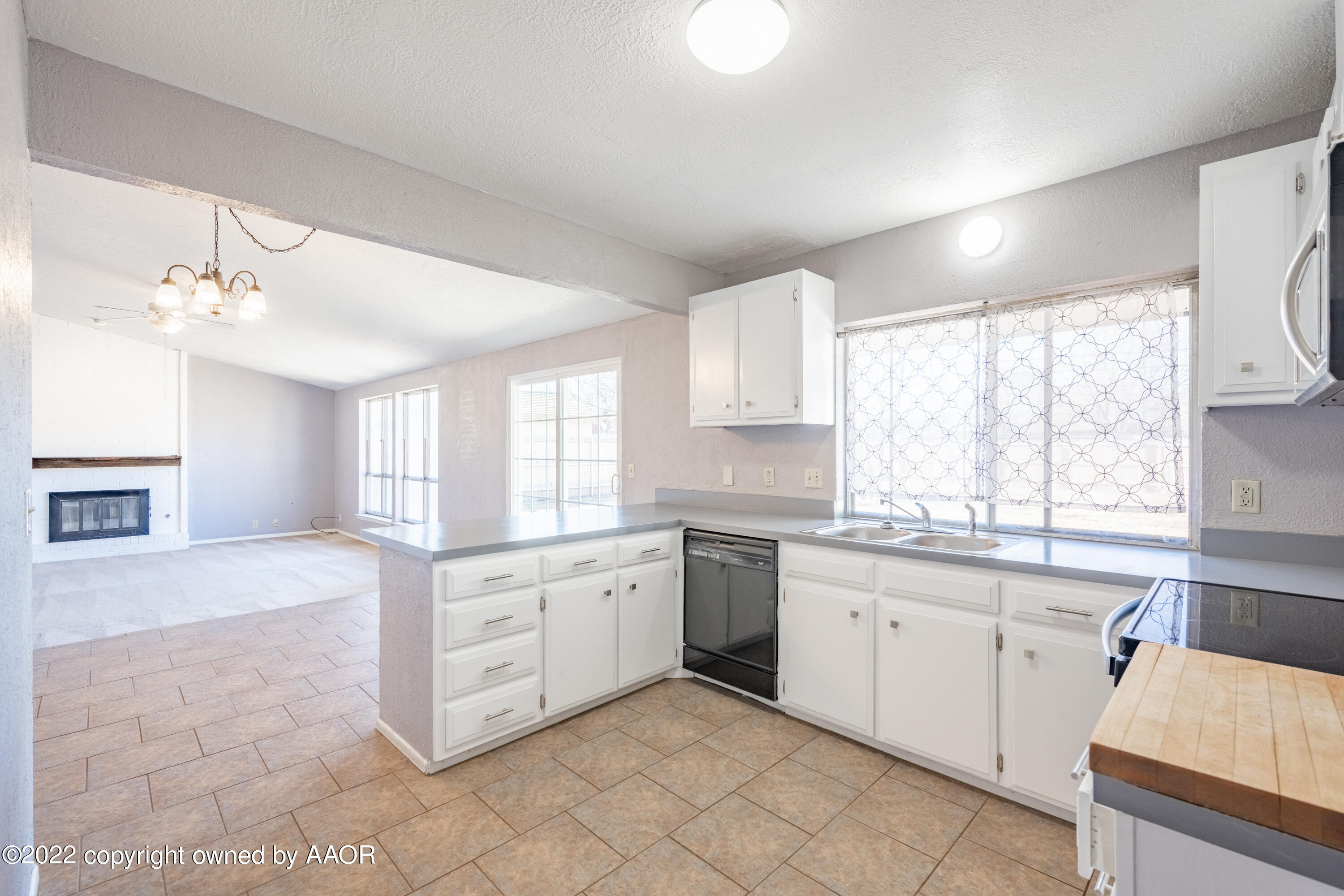 4610 South Georgia Street Amarillo, TX 79110 - Photo 5 of 25 a large white kitchen with a window and cabinets