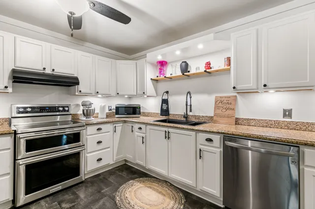 a kitchen with stainless steel appliances and white cabinets