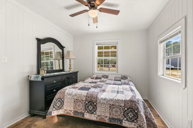 a view of a yard in front of a house with large trees