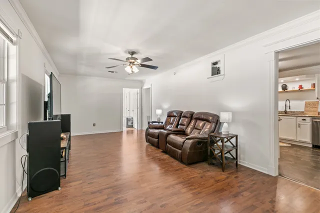 a living room with furniture and a flat screen tv