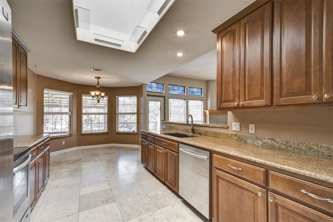 21415 Boggy Ford Road Lago Vista, TX 78645 - Photo 13 of 40 a large kitchen with a large window and stainless steel appliances