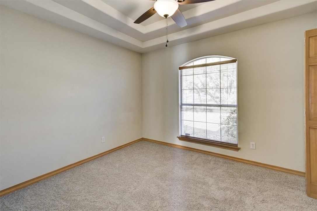21415 Boggy Ford Road Lago Vista, TX 78645 - Photo 21 of 40 an empty room with a empty space and chandelier fan