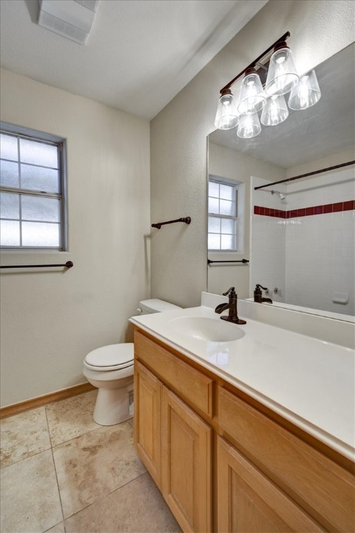 21415 Boggy Ford Road Lago Vista, TX 78645 - Photo 23 of 40 a bathroom with a sink a toilet and a mirror
