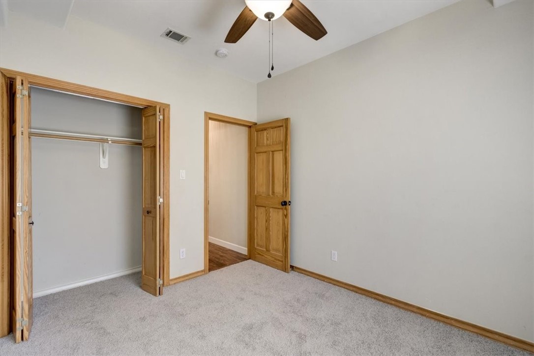 21415 Boggy Ford Road Lago Vista, TX 78645 - Photo 25 of 40 an empty room with closet and a chandelier fan
