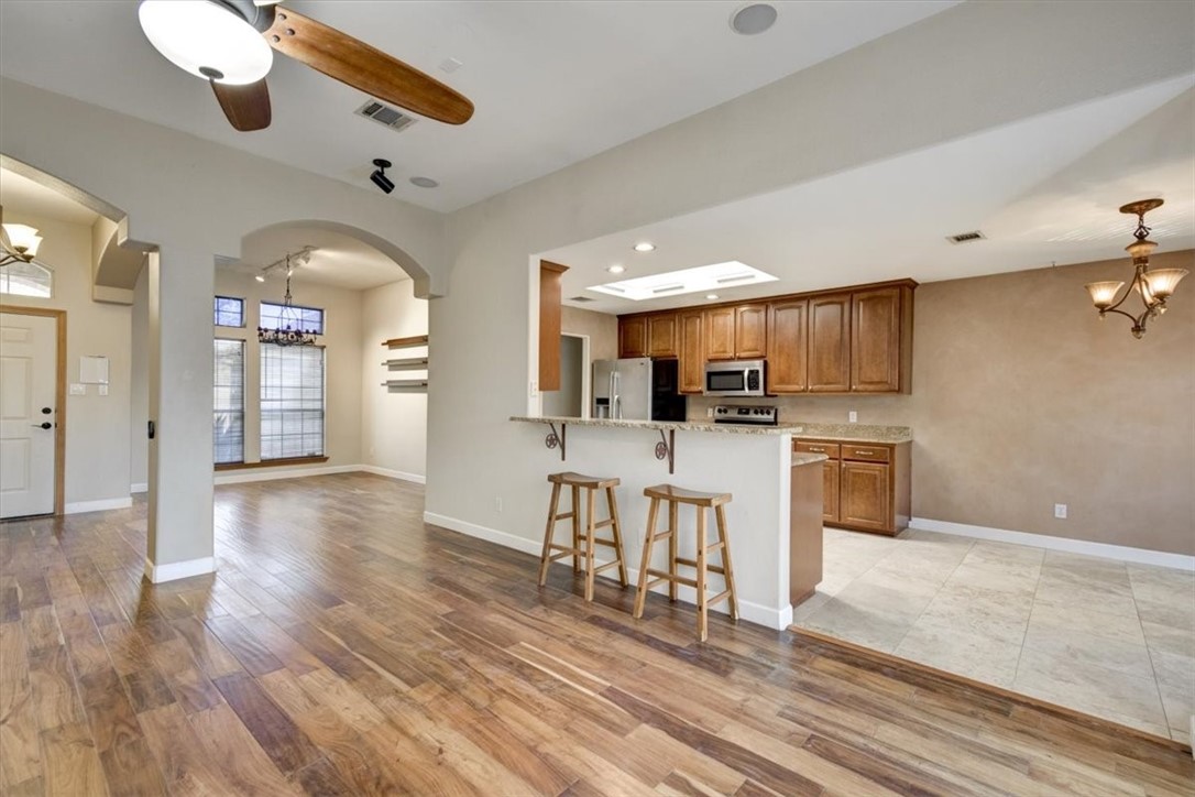 21415 Boggy Ford Road Lago Vista, TX 78645 - Photo 9 of 40 a view of kitchen with cabinets and wooden floor