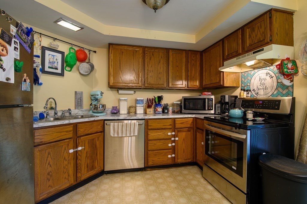 394 Bemis Road Warren, MA 01585 - Photo 7 of 35 a kitchen with stainless steel appliances granite countertop a stove sink and cabinets