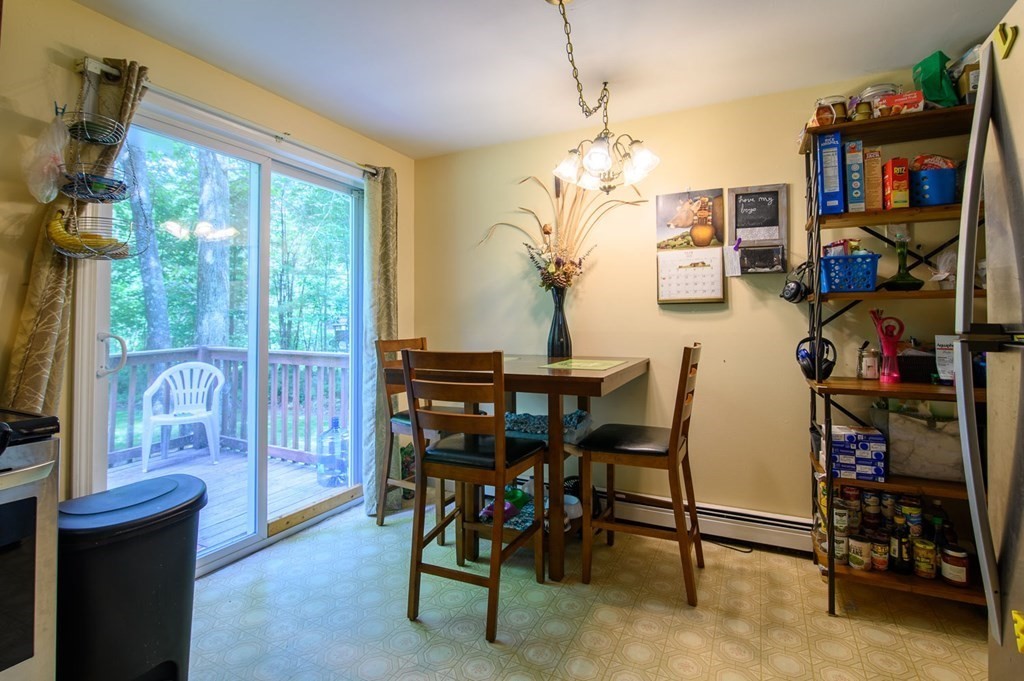 394 Bemis Road Warren, MA 01585 - Photo 8 of 35 a view of a dining room with furniture and a flat screen tv