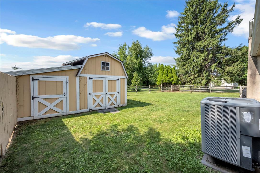 439 Cherry Hill Road Nazareth, PA 18064 - Photo 28 of 31 A quaint barn-style shed provides additional storage in a green backyard with mature trees.