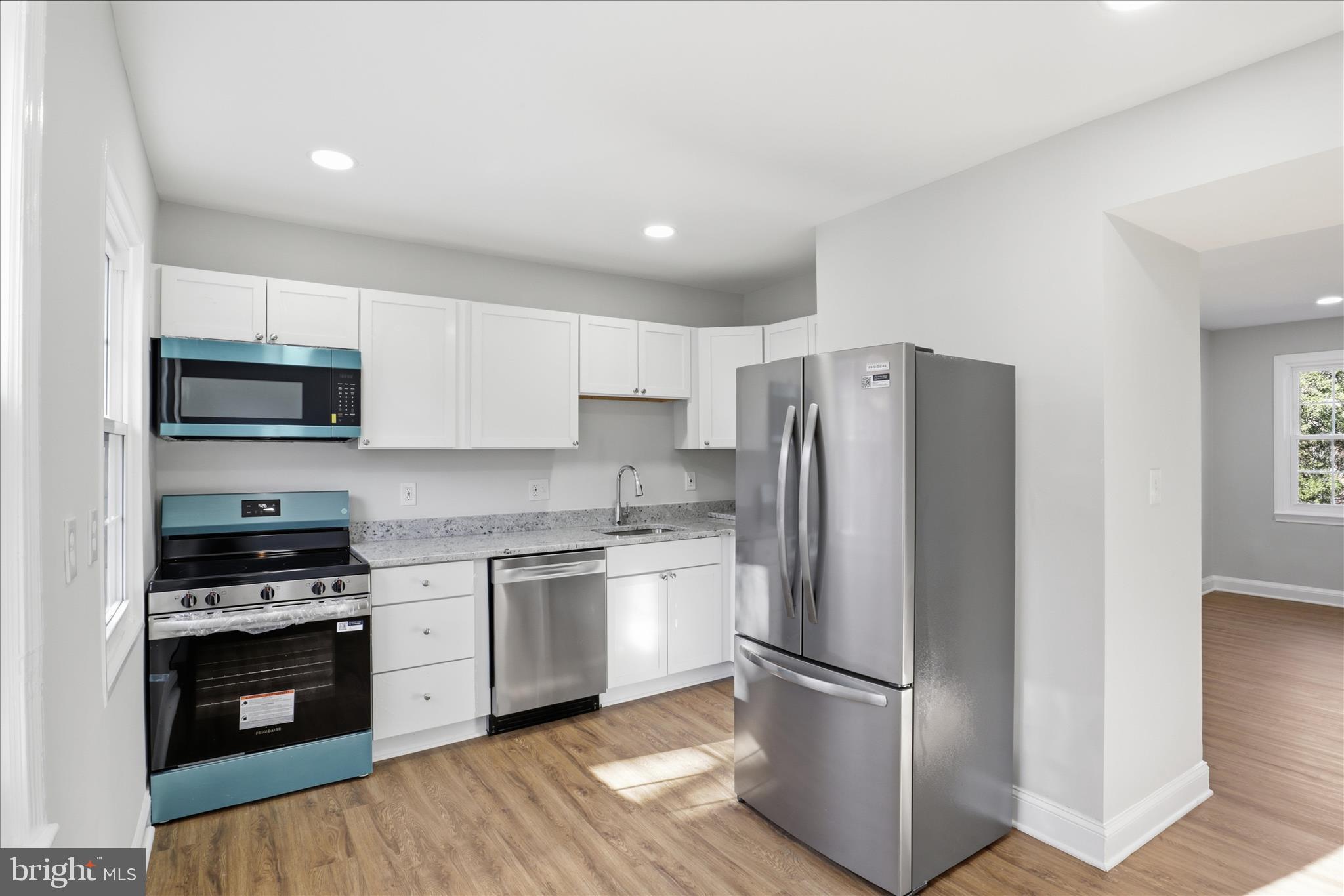 1804 West Abingdon Drive, Unit 201 Alexandria, VA 22314 - Photo 11 of 24 a kitchen with stainless steel appliances granite countertop a refrigerator stove and sink