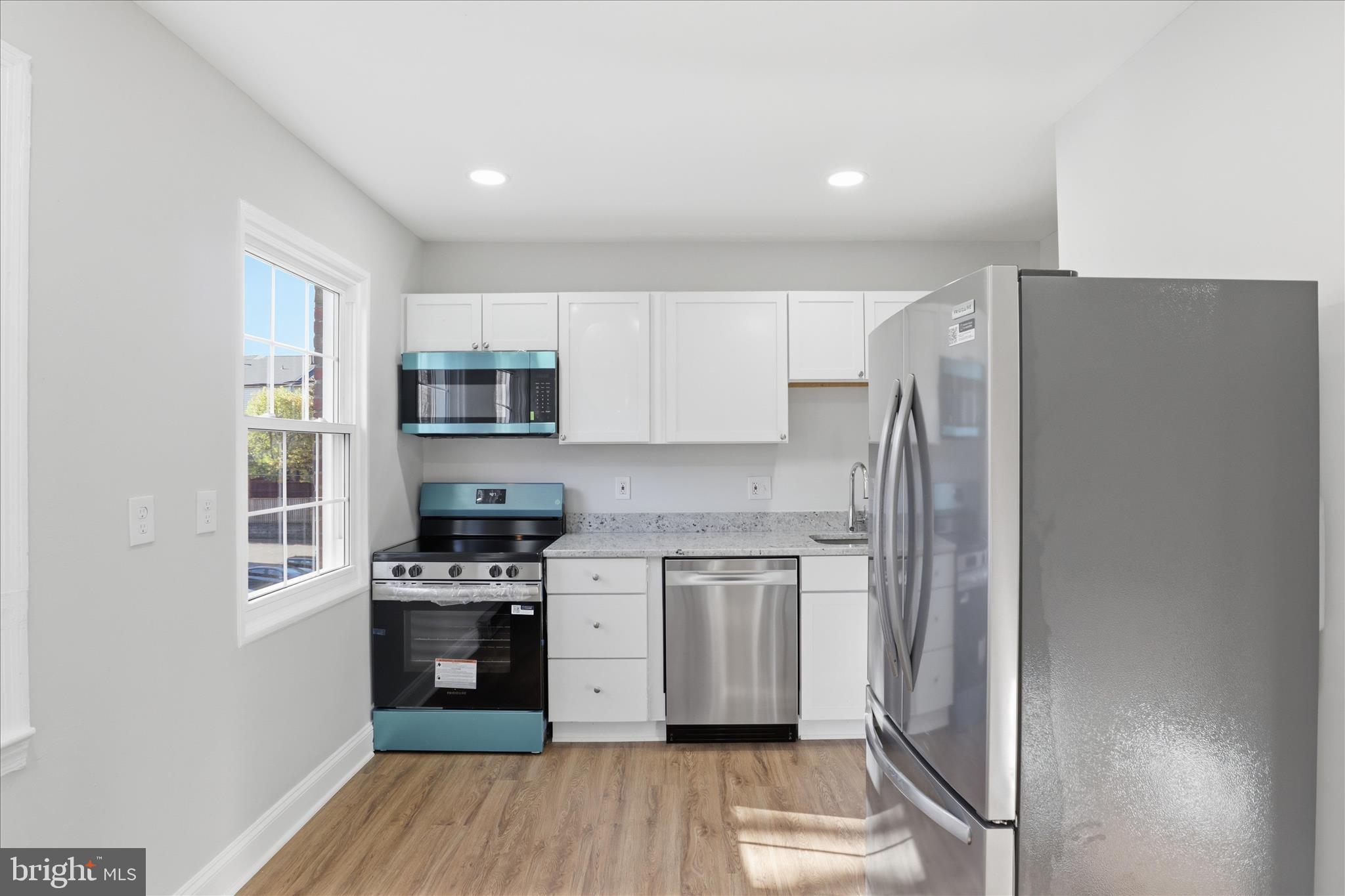 1804 West Abingdon Drive, Unit 201 Alexandria, VA 22314 - Photo 13 of 24 a kitchen with stainless steel appliances a refrigerator stove and microwave