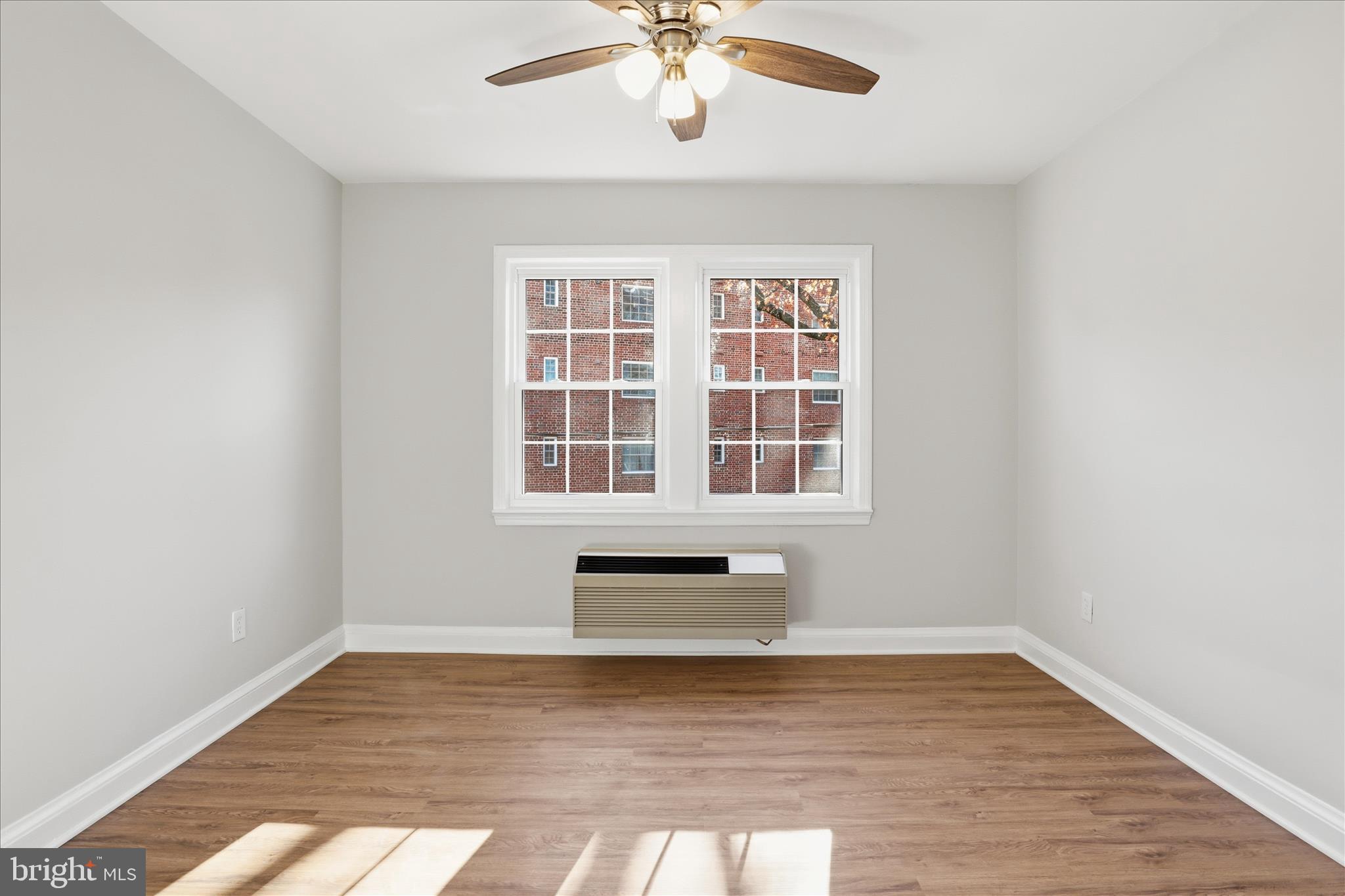 1804 West Abingdon Drive, Unit 201 Alexandria, VA 22314 - Photo 15 of 24 an empty room with wooden floor and windows