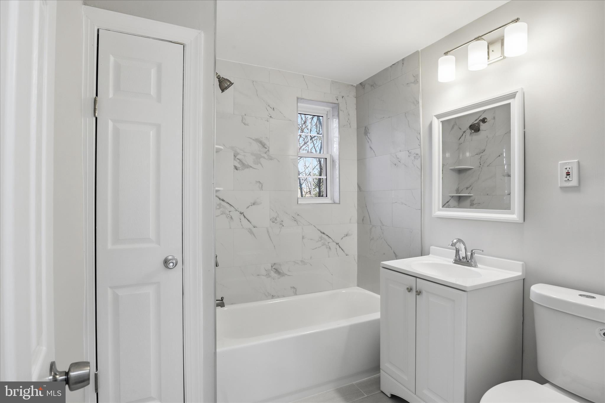 1804 West Abingdon Drive, Unit 201 Alexandria, VA 22314 - Photo 17 of 24 a bath room with a toilet a sink and a bath tub